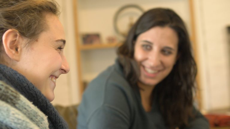 Teacher and student smiling