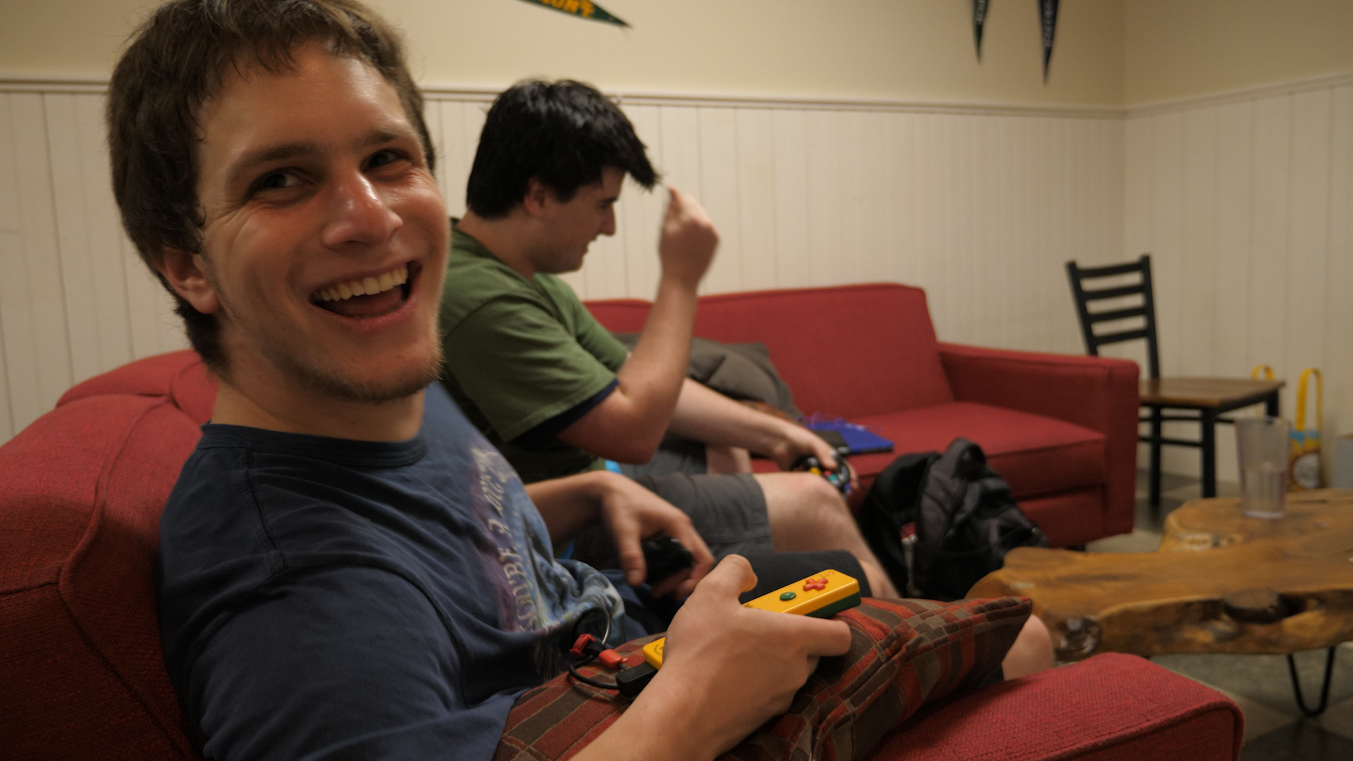 three people sitting in front of table laughing together