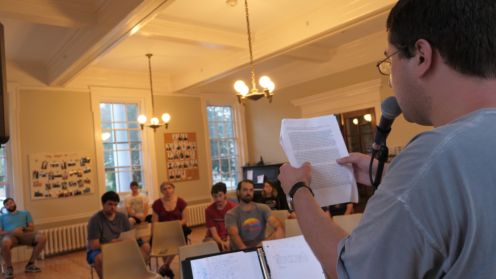 three people sitting in front of table laughing together