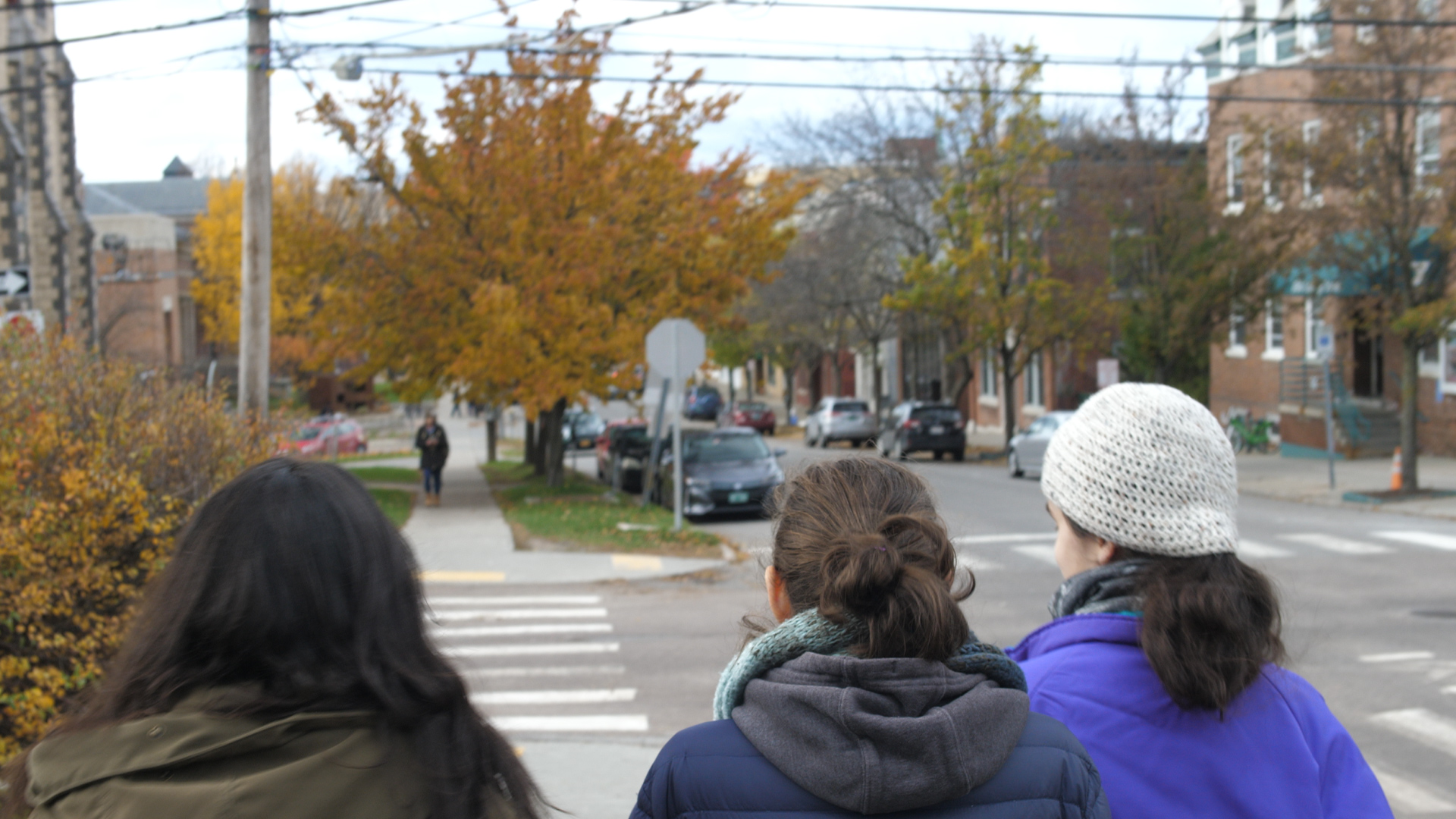 three people sitting in front of table laughing together