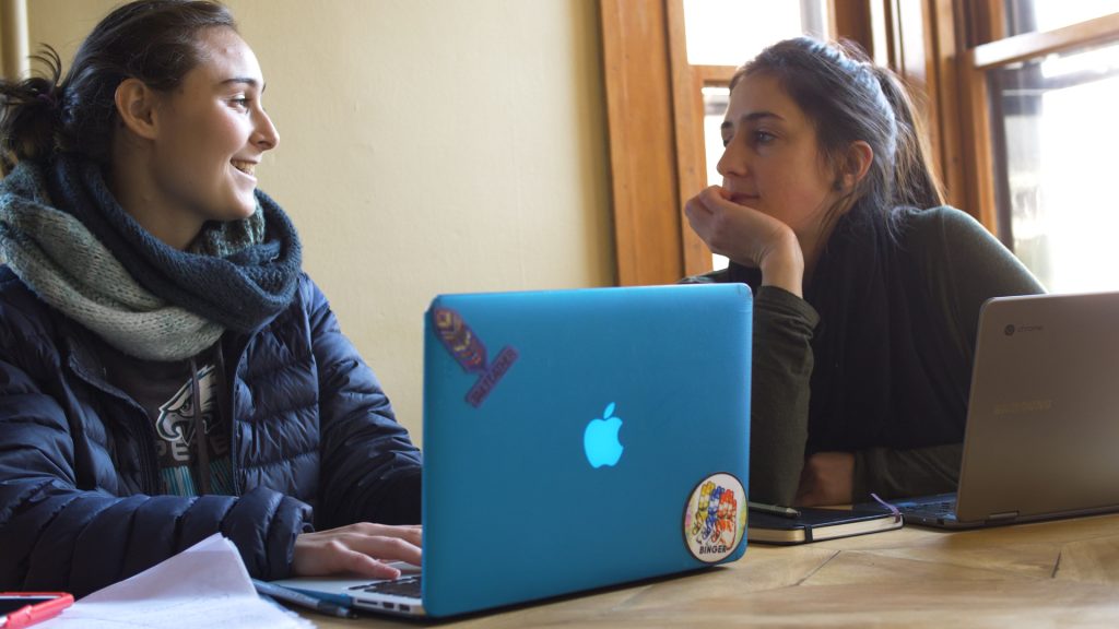 two people sitting together at a table