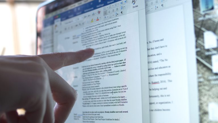 finger pointing out computer screen