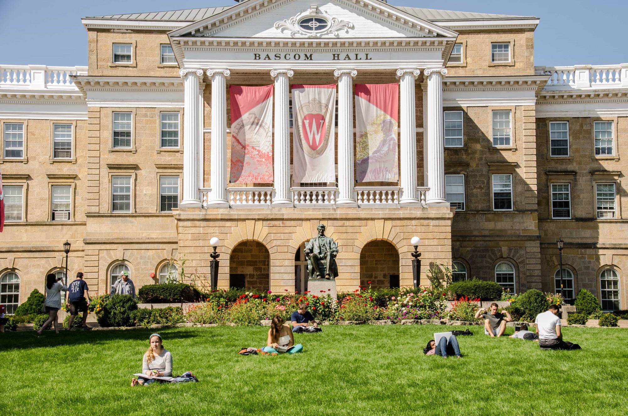three people sitting in front of table laughing together