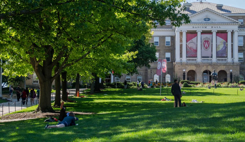 three people sitting in front of table laughing together