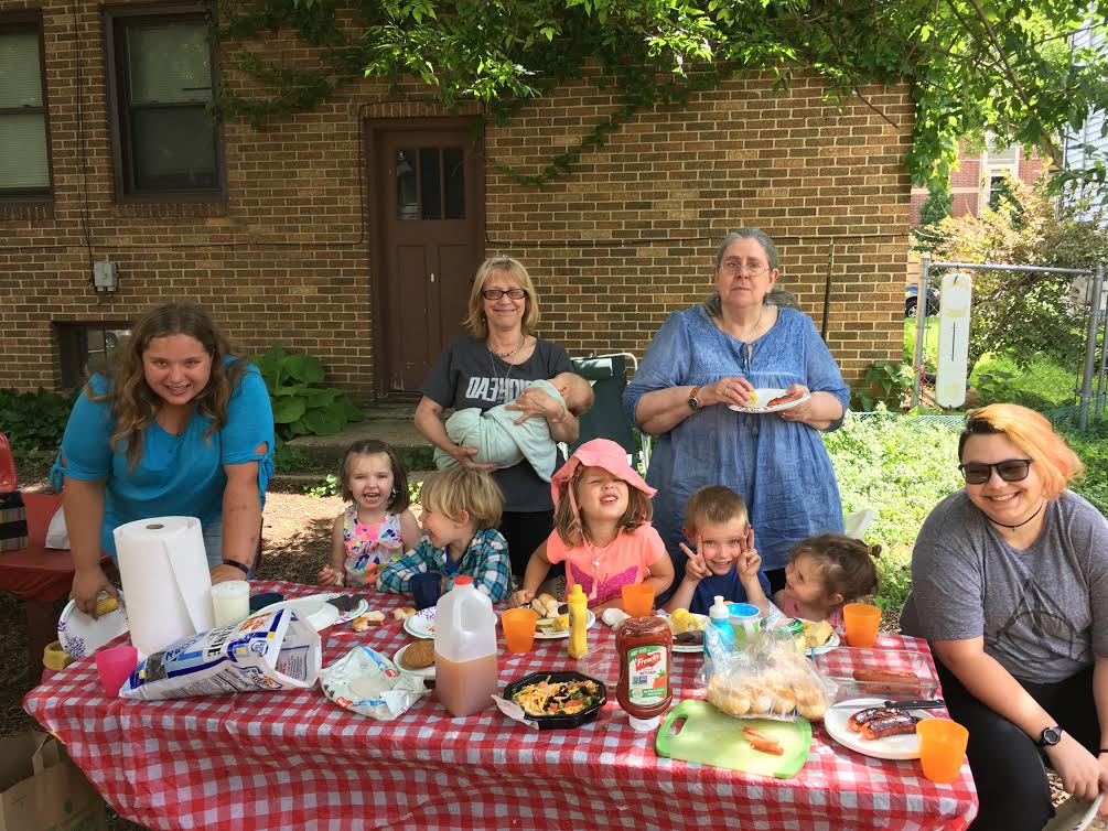 three people sitting in front of table laughing together