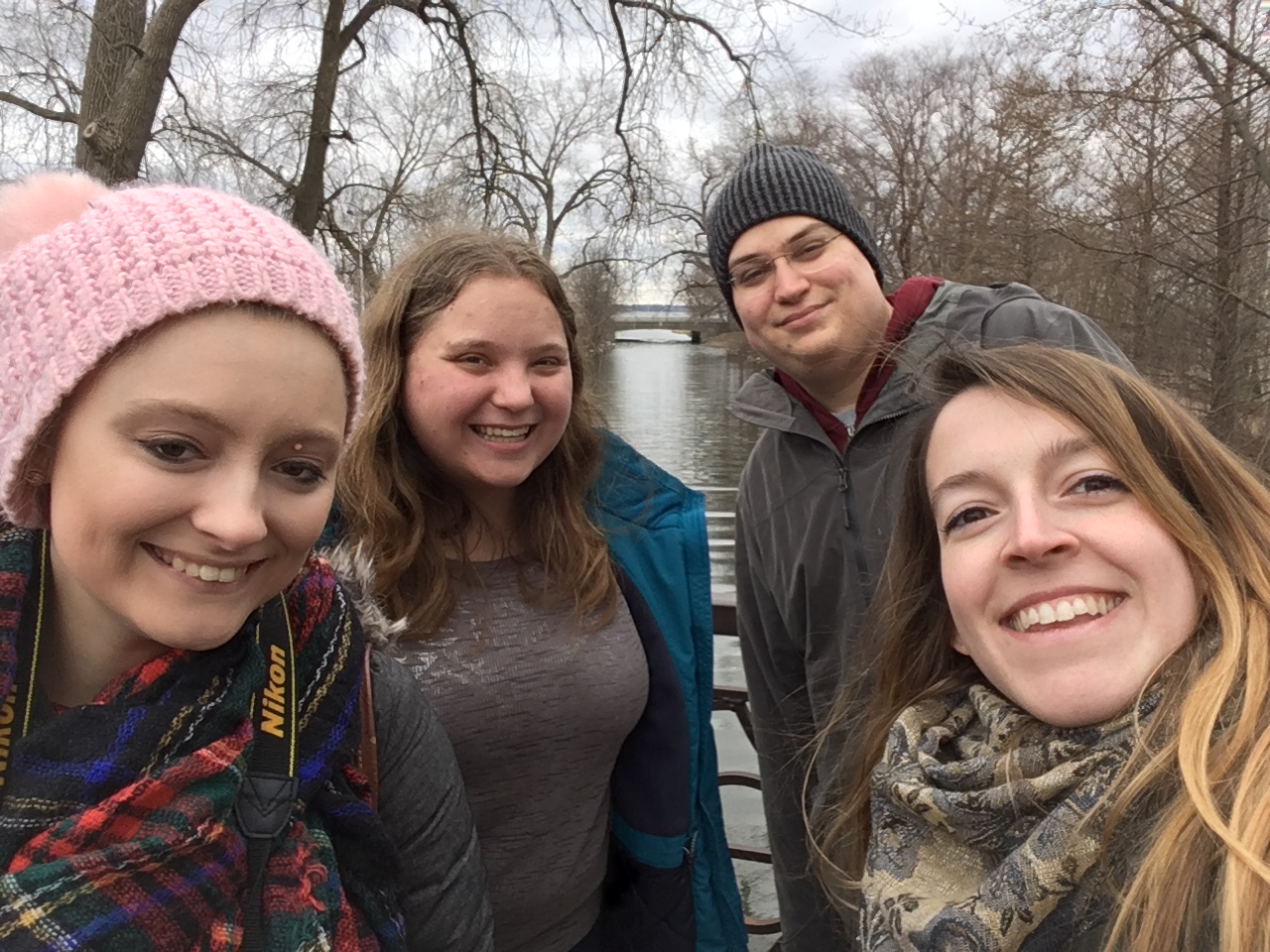 three people sitting in front of table laughing together