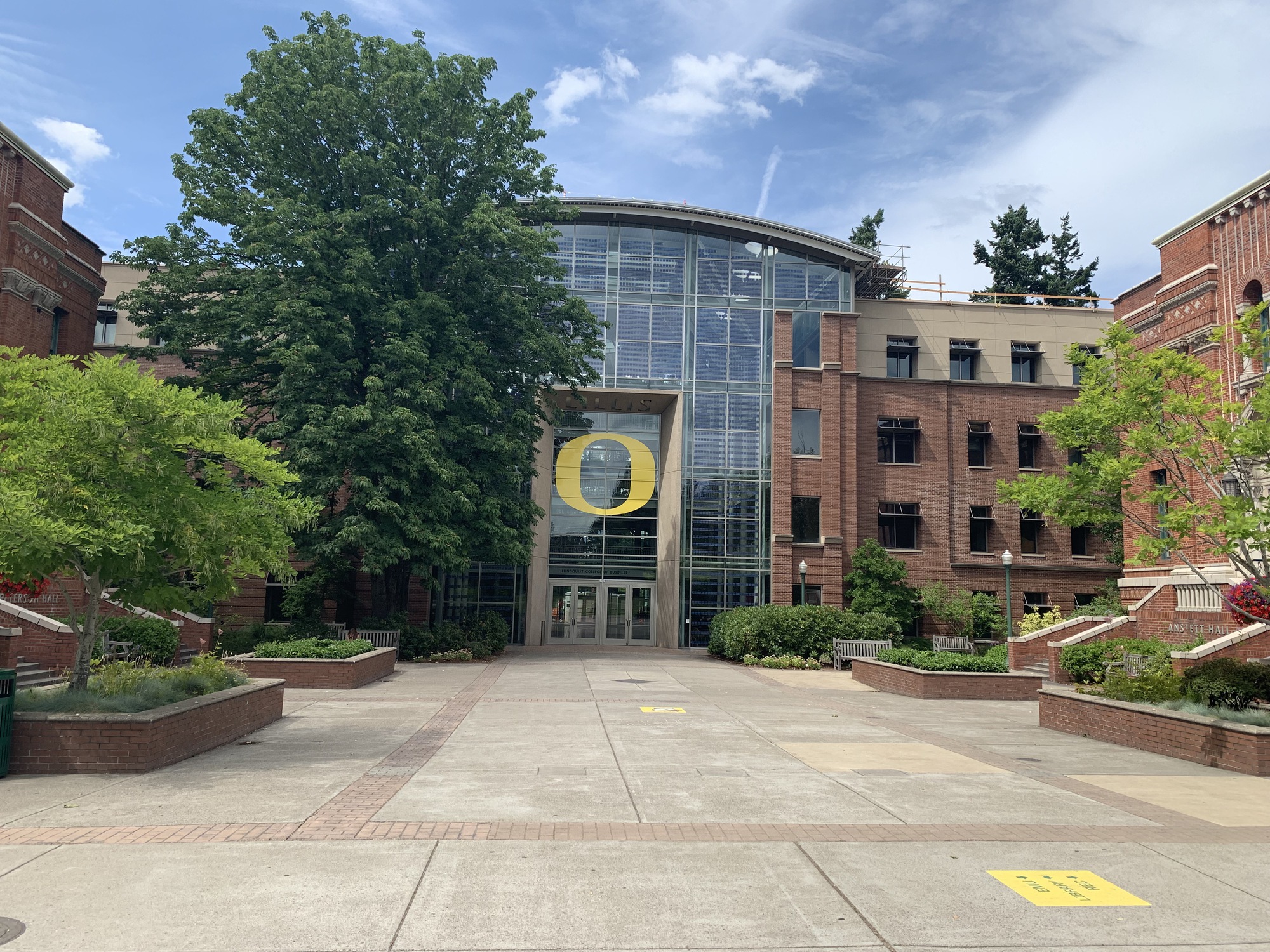 three people sitting in front of table laughing together