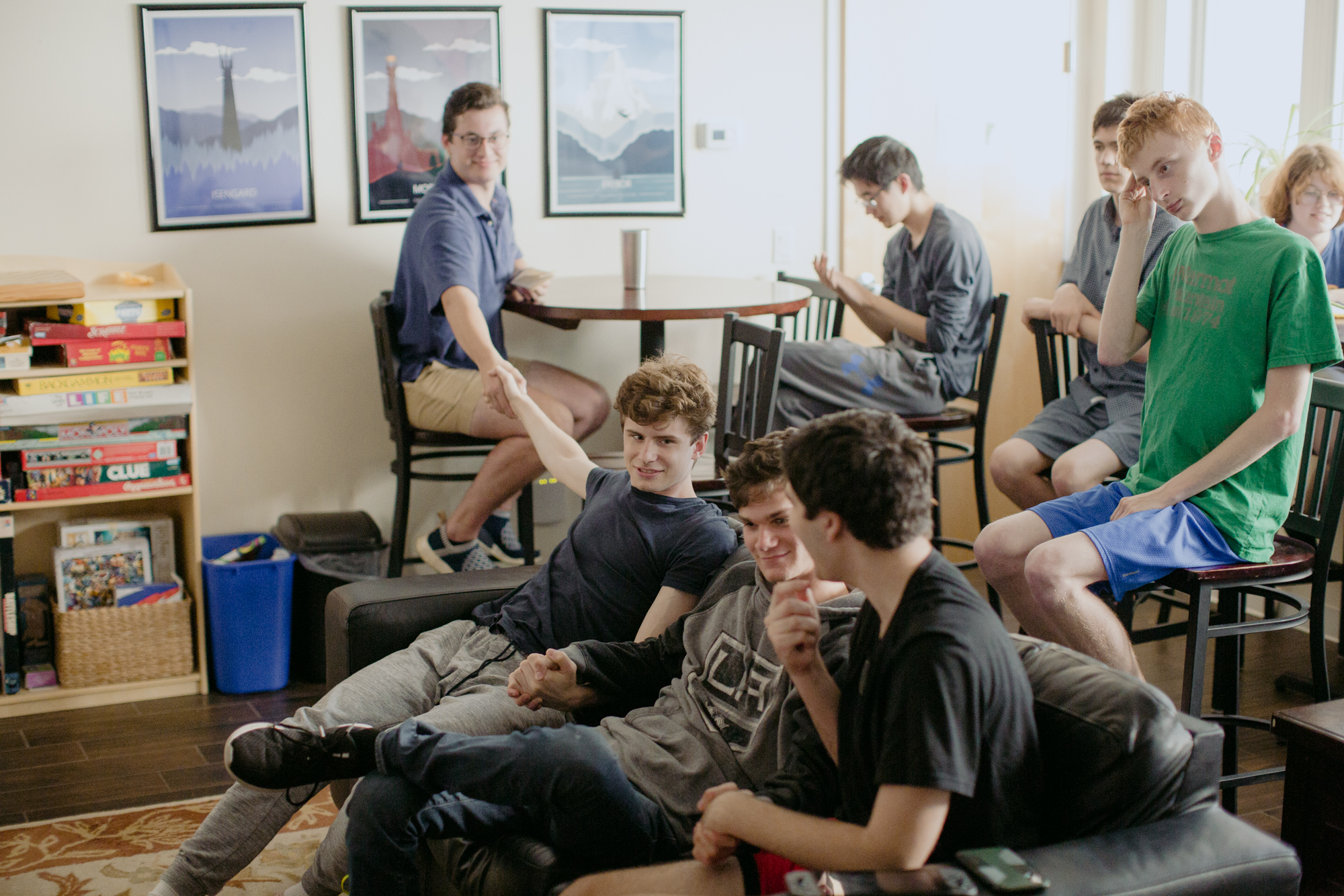 three people sitting in front of table laughing together