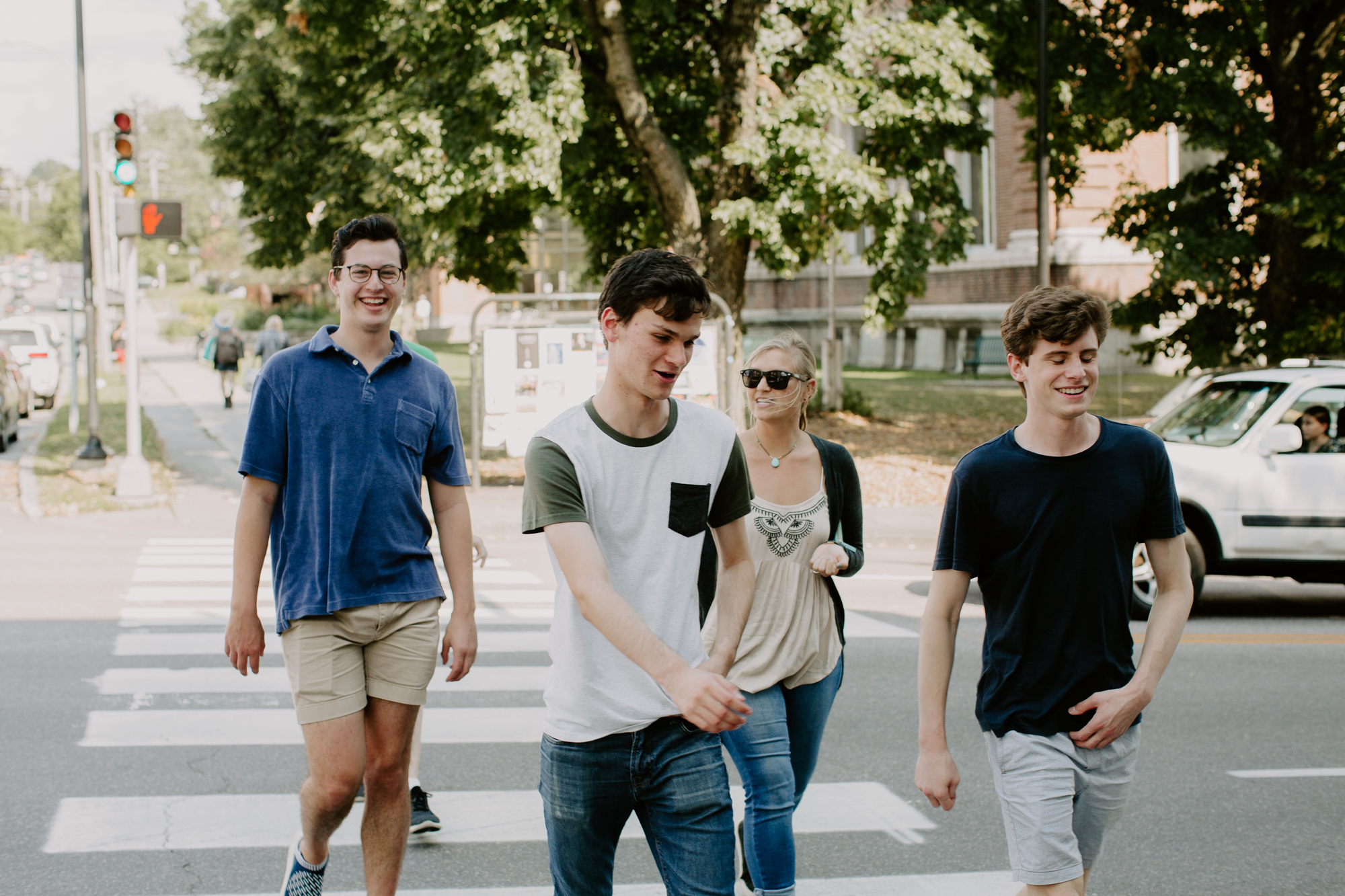 three people sitting in front of table laughing together