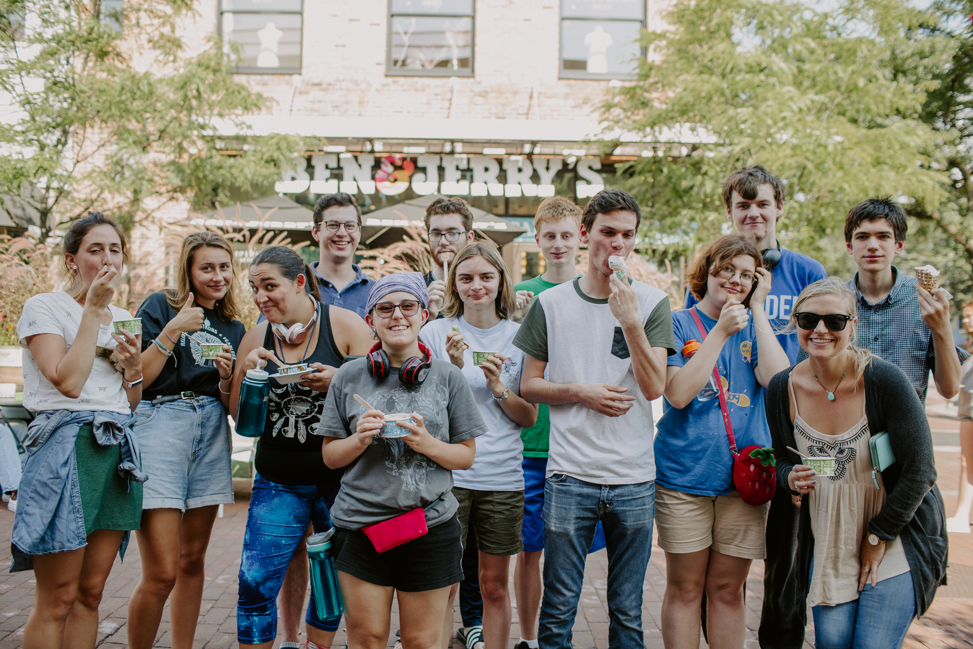 three people sitting in front of table laughing together