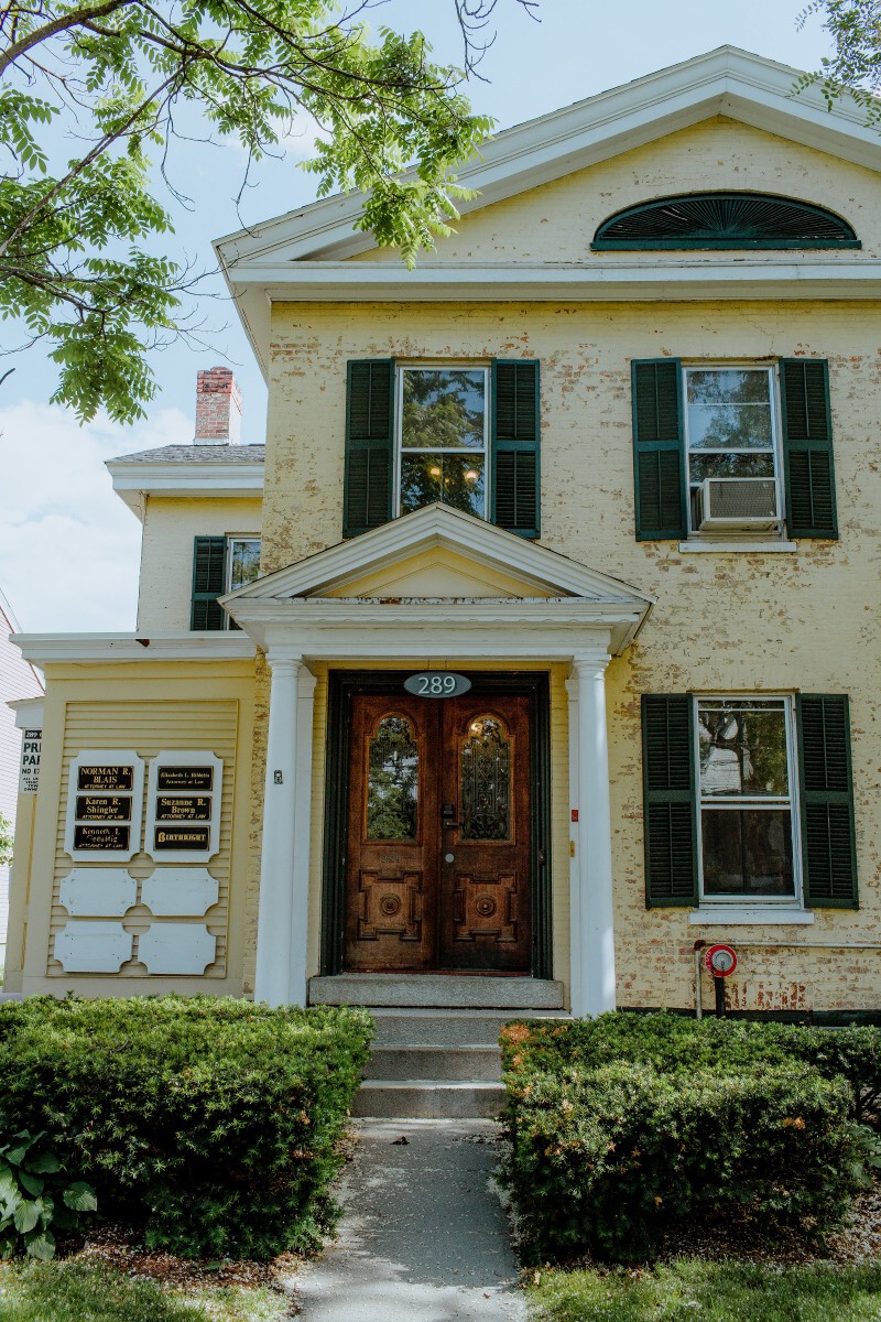 three people sitting in front of table laughing together