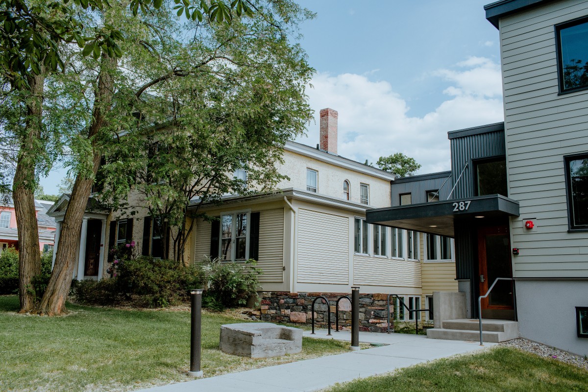 three people sitting in front of table laughing together