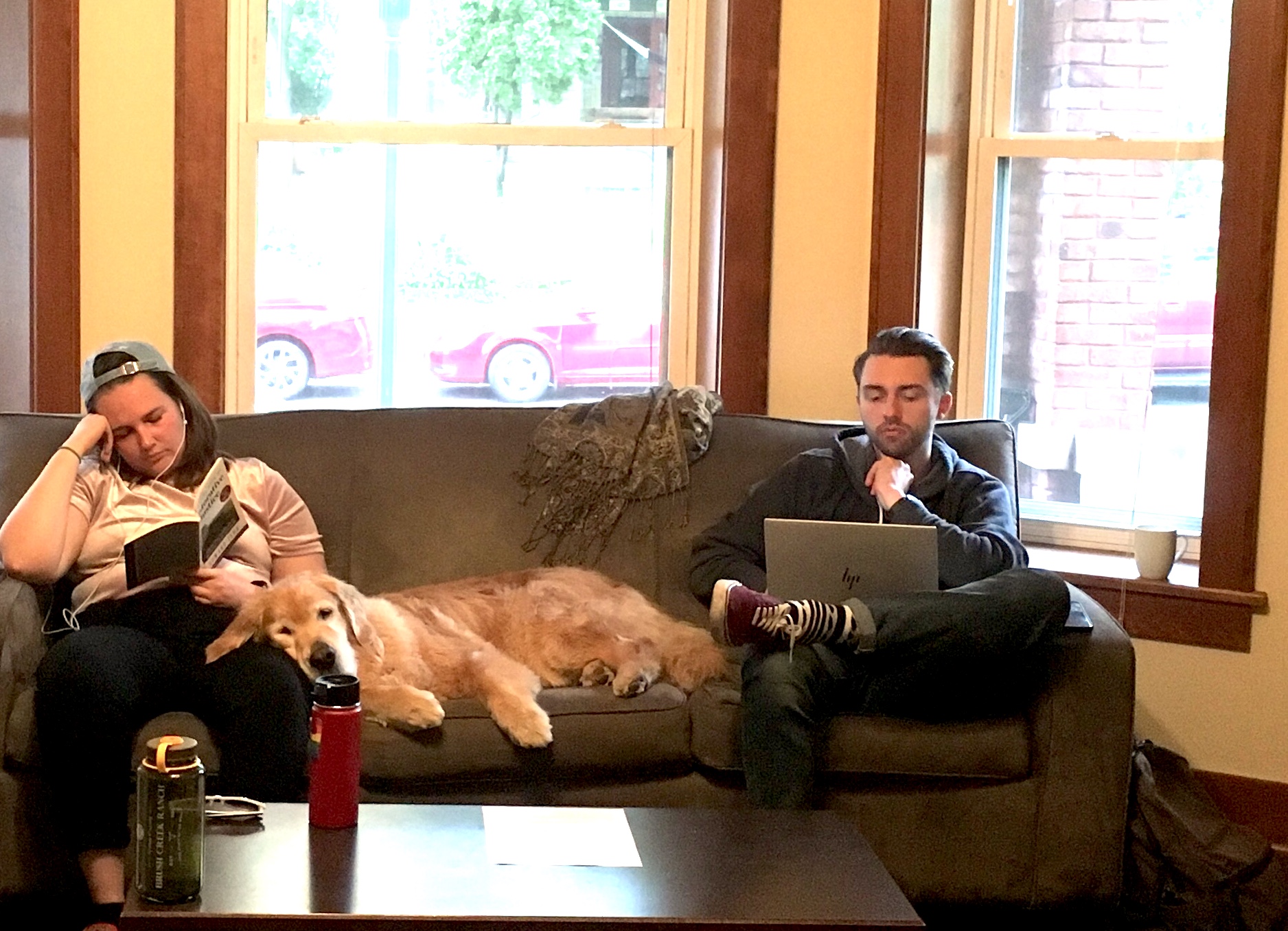 three people sitting in front of table laughing together