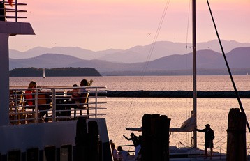 three people sitting in front of table laughing together