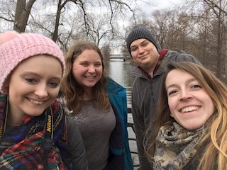 three people sitting in front of table laughing together
