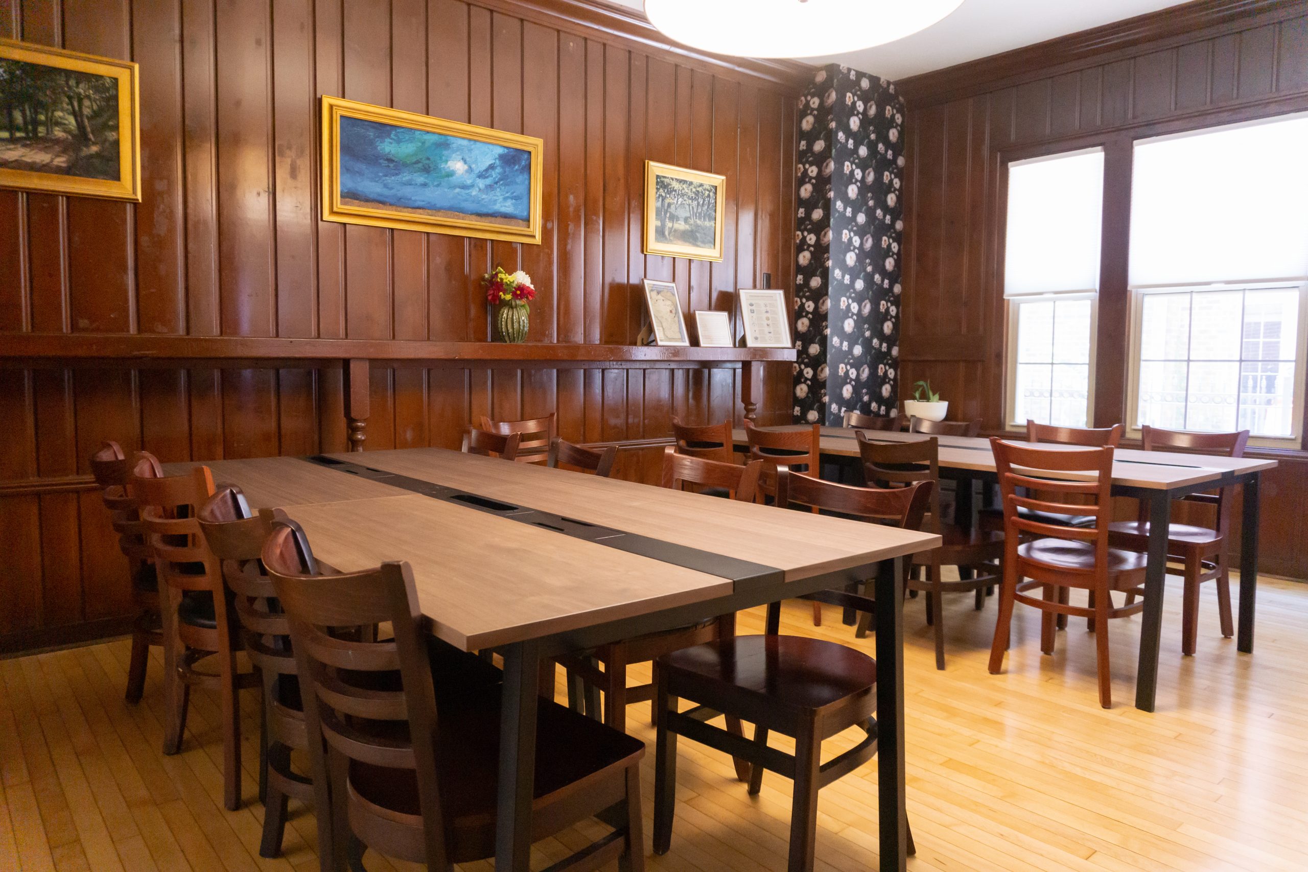 three people sitting in front of table laughing together