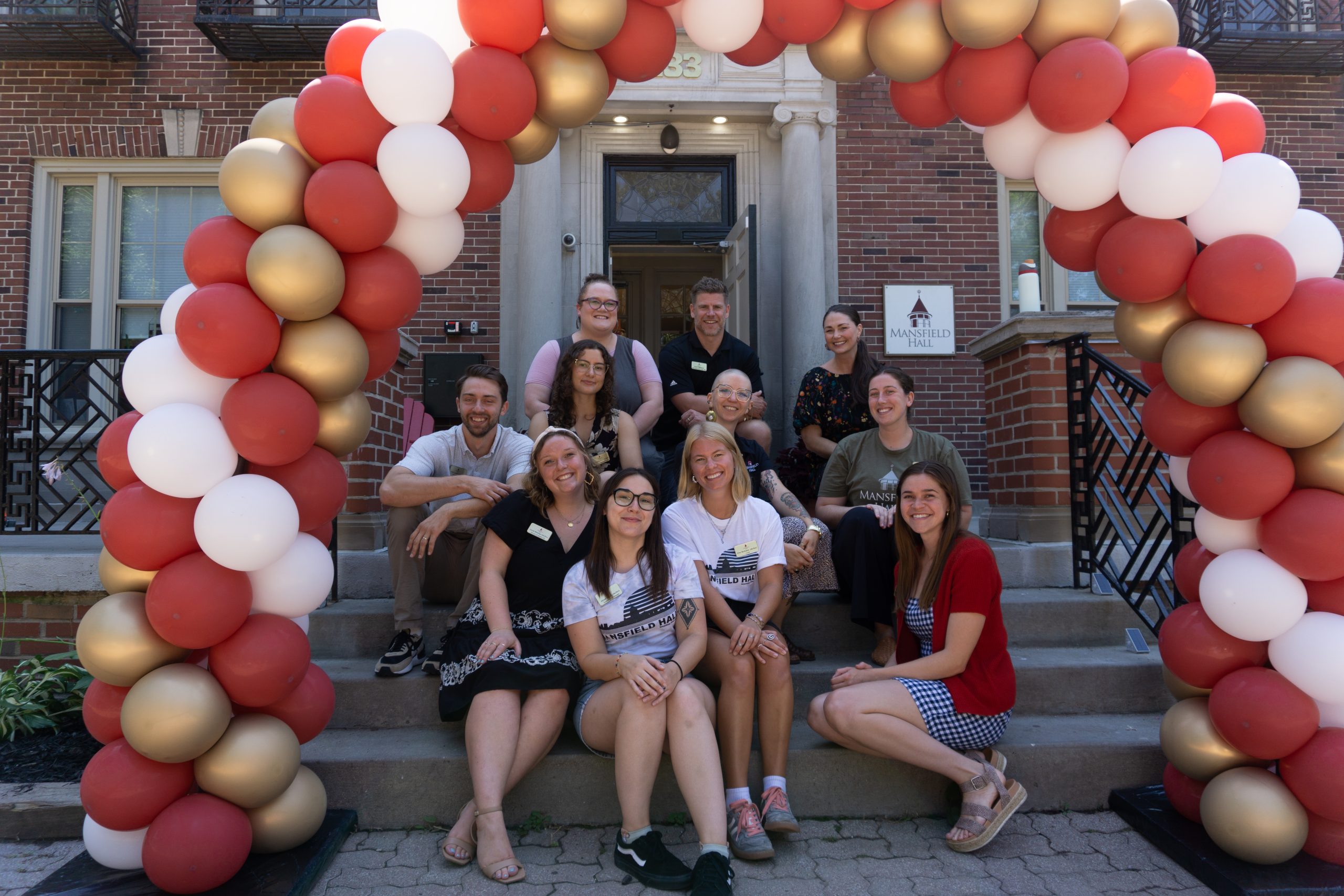 three people sitting in front of table laughing together