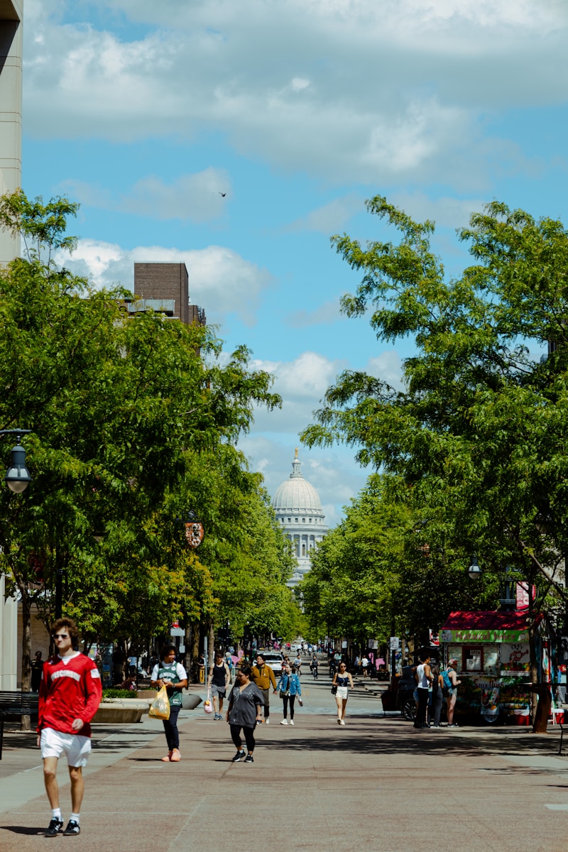 A street leads to a building under a blue sky.